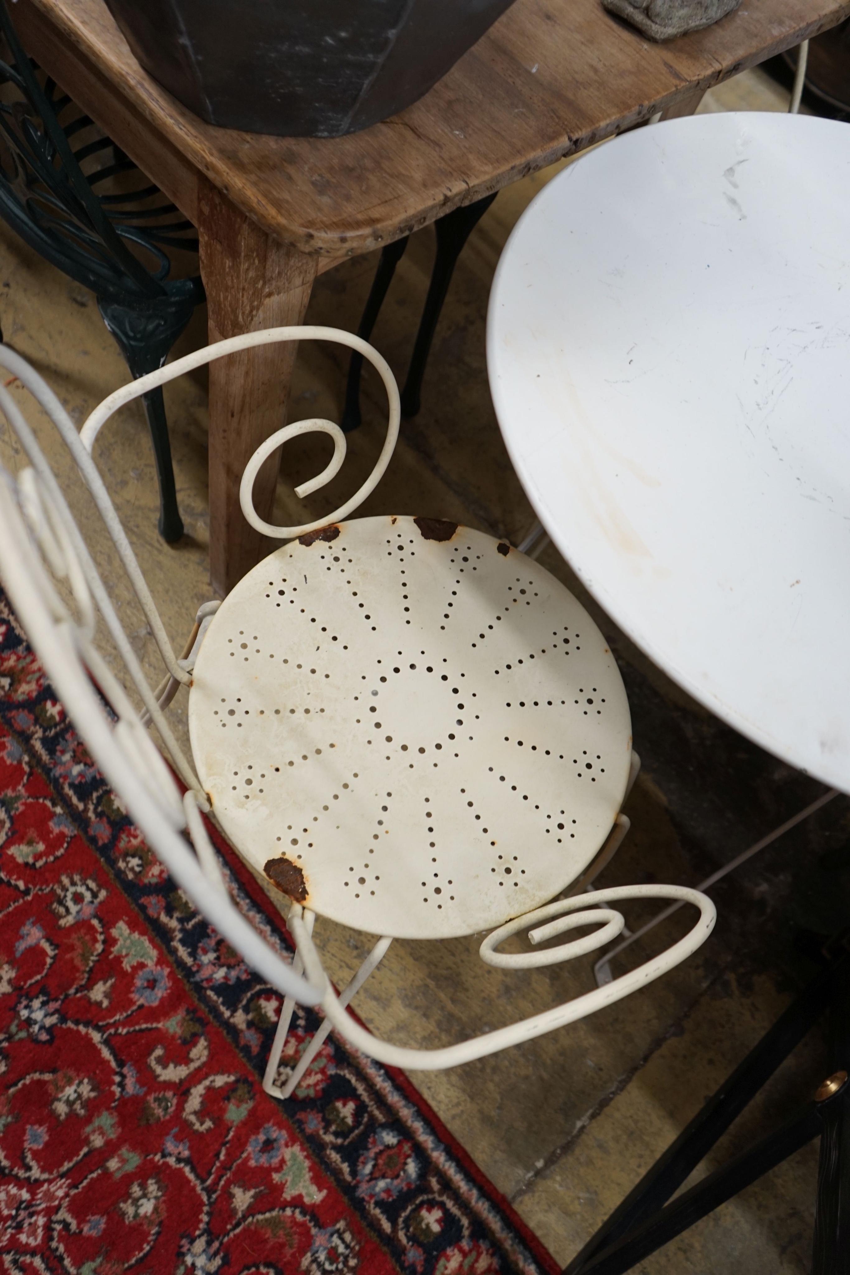 A circular metal folding bistro table, diameter 70cm, height 72cm and two chairs